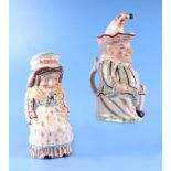 A pair of Staffordshire pottery jugs and covers in the form of Punch and Judy, 29cm high,(2)