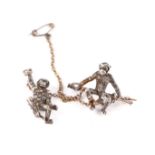 An Edwardian double monkey brooch, circa 1905, with two naturalistically modelled silver monkeys,