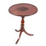 A 19th century mahogany tripod table, the circular dished top with central carved decoration, on a
