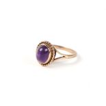 A 9ct gold ring set with an amethyst cabochon. Approx. UK size N.2.8g