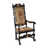 A 17th century style ebonised and gilt show wood upholstered armchair with scroll arms and feet.