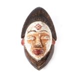 A painted carved softwood African tribal mask, 33cms high.