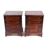 A pair of Georgian style bowfronted bedside cabinets with four long drawers, on bracket feet,