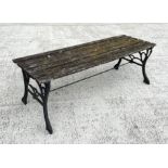 A well weathered slatted wooden garden bench with cast iron supports, 122cm wide.