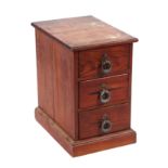 A late 19th century pitch pine bank of three drawers, on a plinth base, 26cms wide.