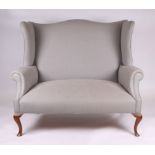 A wingback two seater sofa on cabriole front supports, 129cm wide.