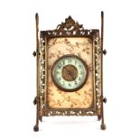 A late Victorian/Edwardian brass strut mantle clock having a porcelain chapter ring with Roman