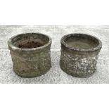 A pair of reconstituted stone cylindrical planters decorated with classical figures, 41cms