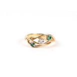An 18ct gold diamond and emerald ring. Approx. UK size M.4.1g