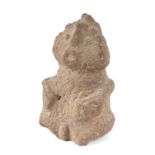 A pre-Columbian volcanic stone figure with feathered headdress, 18cms high.