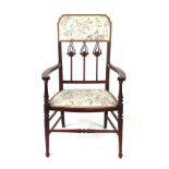 An Art Nouveau inlaid elbow chair with upholstered seat and back.