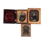 A group of ambrotypes, one in a vulcanite case.