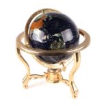 A terrestrial globe mounted with specimen stones, on a brass stand, 38cms high.