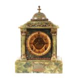 An early 20th century American green marble mantle clock, the gilt dial with Roman numerals and open