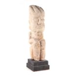 A pre-Columbian votive stone figure, on a later stand, 39cms high. Condition Report Old repair