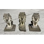 A group of three reconstituted stone seated lions, 44cm high. (3)