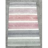A modern Designer's Guild floor rug with pastel shade stripes, 245 by154cms.