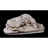 A Parian type figure of a recumbent lurcher with impressed registration no: 4782 to the underside,