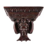 A 19th century carved oak wall bracket, depicting the head of a young woman, 31cm wide,