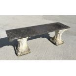 A garden bench with reconstituted stone pedestals and a slate seat, 128cm wide.
