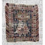 An antique Caucasian rug, 100 by 114cms (wear and damages).