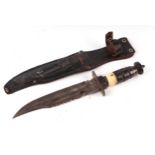 An early 20th century sawback Bowie knife in its leather scabbard. Havinga part bone hilt. Blade