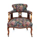An Edwardian tub chair with upholstered seat and back, on cabriole front supports.