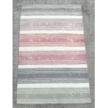 A modern Designer's Guild floor rug with pastel shade stripes, 245 by154cms.