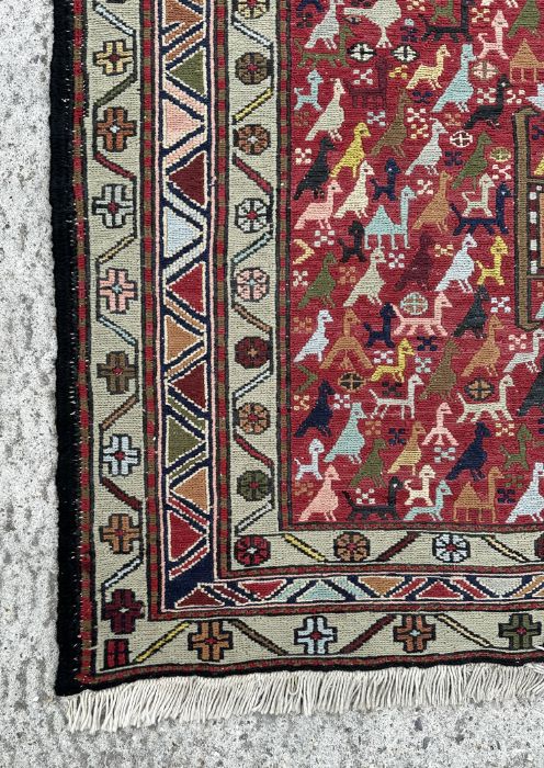 A Persian flatweave rug decorated with a multitude of stylised animals within a geometric border, on - Image 3 of 4