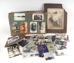 An early 20th century postcard album; together with a quantity of photographs and ephemera.