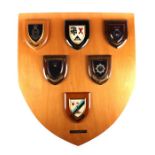 A large wooden Presentation shield 70.5cms (27.75ins) wide by 80cms (31.5ins) high, with six