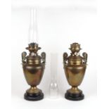 A pair of Victorian brass oil lamps, 40cms high excluding flues. Condition Report One flue