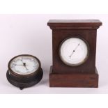 An aneroid barometer in an oak case; together with a wall mounted barometer (2).
