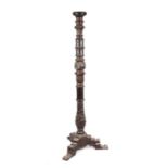 A Victorian carved oak torchere on triform base, 164cms high.