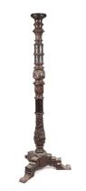 A Victorian carved oak torchere on triform base, 164cms high.