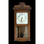 An early 20th century oak cased wall clock, the silver dial with Arabic numerals, 75cm high.