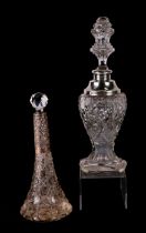 Two silver mounted cut glass scent bottles with associated stoppers, the largest 26cms high.