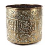 A large Islamic brass planter with central band of calligraphy within borders depicting animals