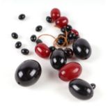 A group of cherry amber Bakelite loose beads, the largest bead 28mm long, 43g. Condition Report