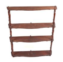 A Victorian three-tier pine hanging bookshelves with turned supports, 62cms wide.