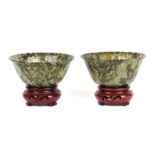 A pair of Chinese spinach jade bowls on stands, 10cms diameter. Condition Report One bowl has been