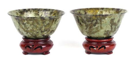 A pair of Chinese spinach jade bowls on stands, 10cms diameter. Condition Report One bowl has been