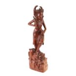 A Burmese carved teak temple figure, 54cms high.