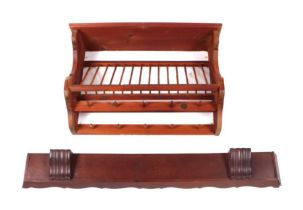 A pine wall mounted plate rack, 76cms wide; together with a walnut plate shelf, 120cms wide (2).