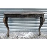 A George II style carved wood console table, the breakfront rectangular top with canted corners,