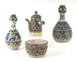 An Iznik pottery bottle vase with traditional glazed decoration, approx 27cms high; together with