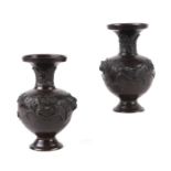 A pair of Japanese bronze baluster vases decorated with birds and prunus, 19cms high.