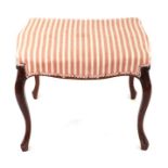 A Regency style upholstered footstool on cabriole legs, 56cms wide.