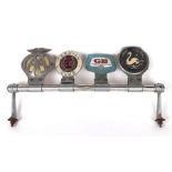 A chrome plated badge bar with four badges to include AA and Caravan Club.