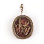 An 18th century religious reliquary locket dedicated to four different saints, mounted on an